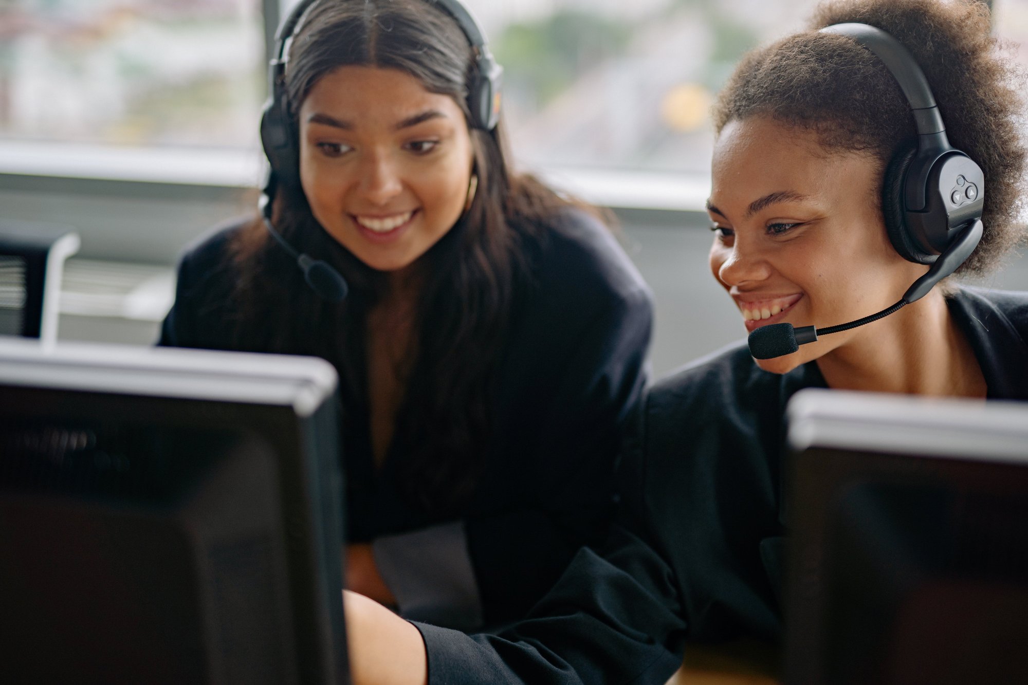 two support agents discussing meeting booking