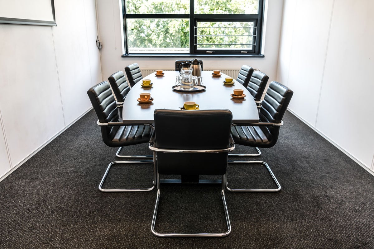 Small meeting room with black chairs
