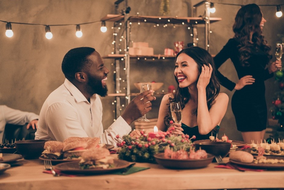 Two people talking to each other over Chirstmas table