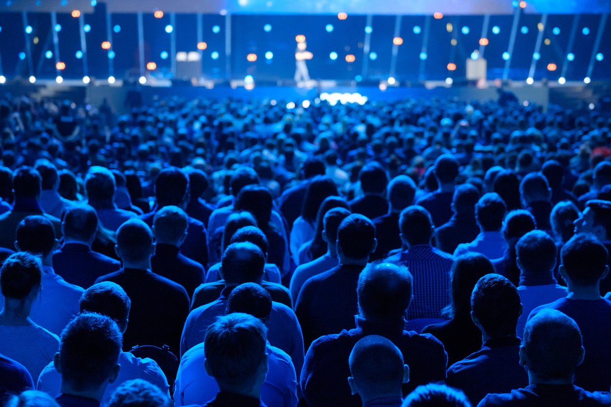 large group in front of a stage at an event